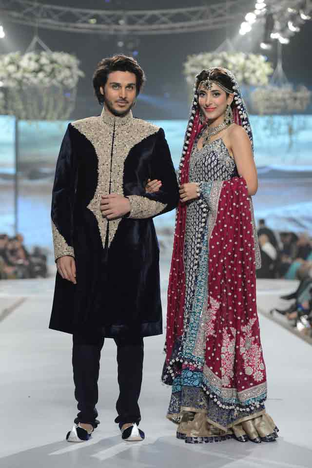 Bridal in grey black long shirt with sharara and red dupatta and groom in embroidered black matching sherwani with pajama or trouser latest indian and pakistani wedding matching dress combinations for bride and groom 2017