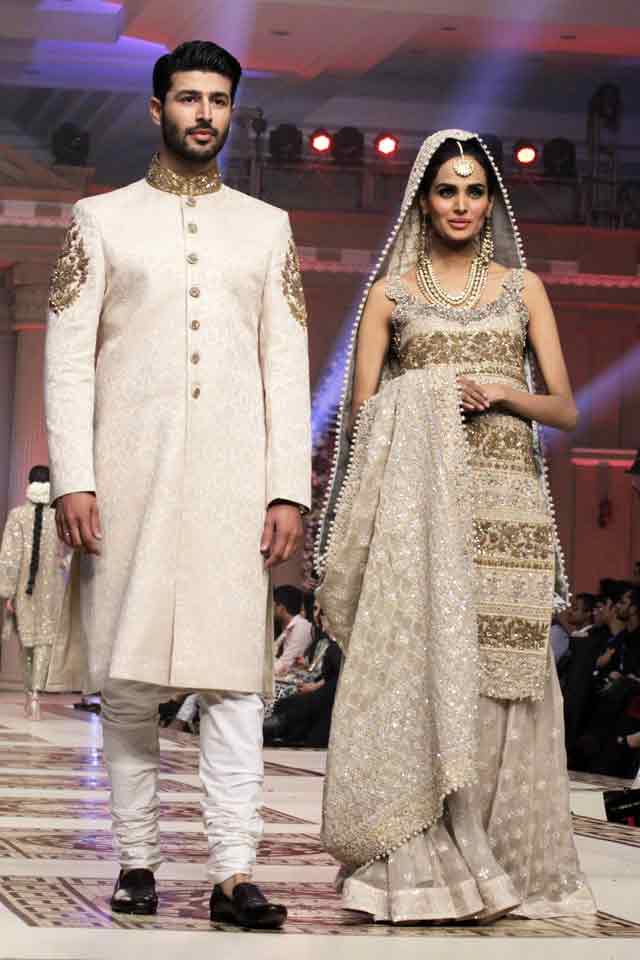 Bridal in Embroidered ash grey long shirt and sharara or gharara and groom in matching white sherwani with white trouser or pajama latest indian and pakistani wedding matching dress combinations for bride and groom 2017