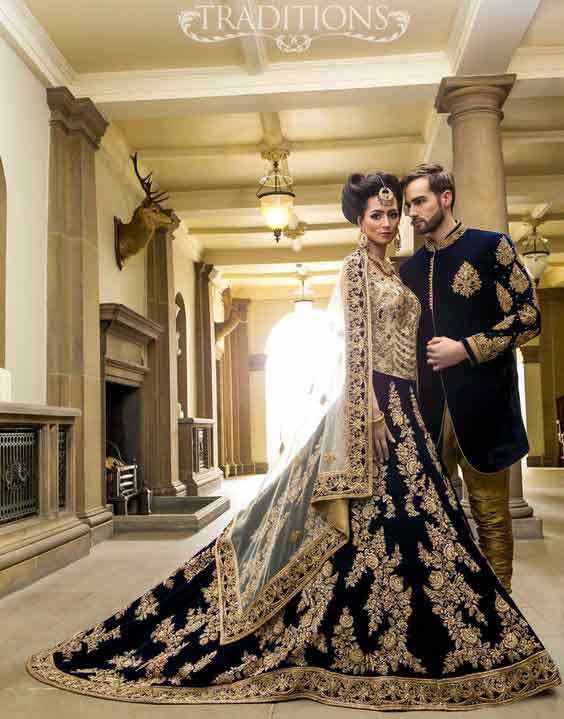 Bridal in long tail dark blue lehnga choli and groom in matching short sherwani with golden pajama latest indian and pakistani wedding matching dress combinations for bride and groom 2017