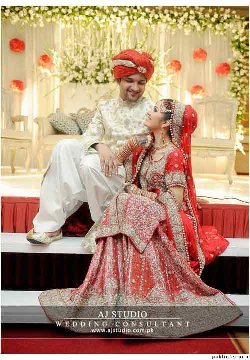 Bridal in red long shirt with lehnga and groom in white sherwani with red turban latest indian and pakistani wedding matching dress combinations for bride and groom 2017
