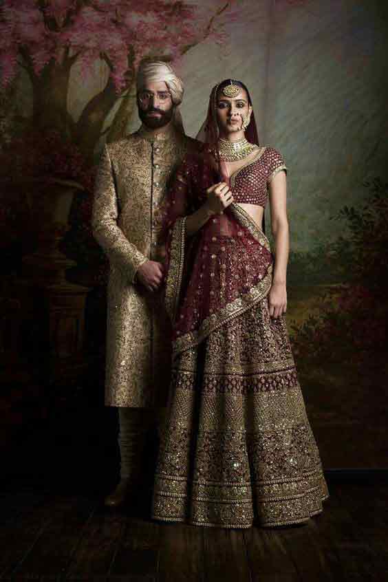 Bridal in maroon lehnga choli with dupatta and groom in cream sherwani latest indian and pakistani wedding matching dress combinations for bride and groom 2017