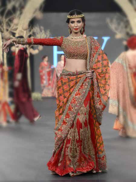 Pakistani saree designs in orange and red colors for wedding brides